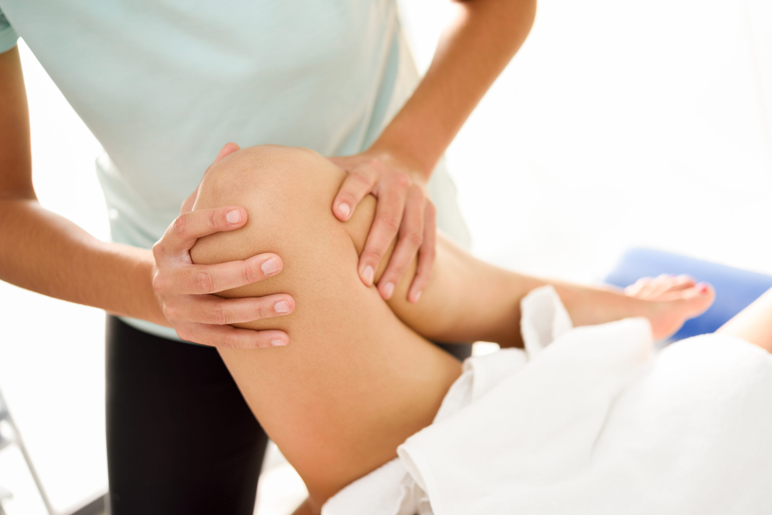 medical massage at the leg in a physiotherapy center.